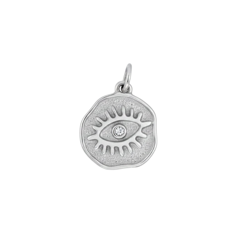 HOUSE OF EVEN silver evil eye medallion charm with a central clear crystal, made from tarnish-resistant steel.